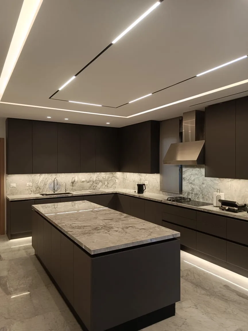KZ kitchen executed in Ghazze, Beqaa Lebanon — handleless dark brown matte cabinetry with Super White quartzite waterfall island — KITWOOD completed project