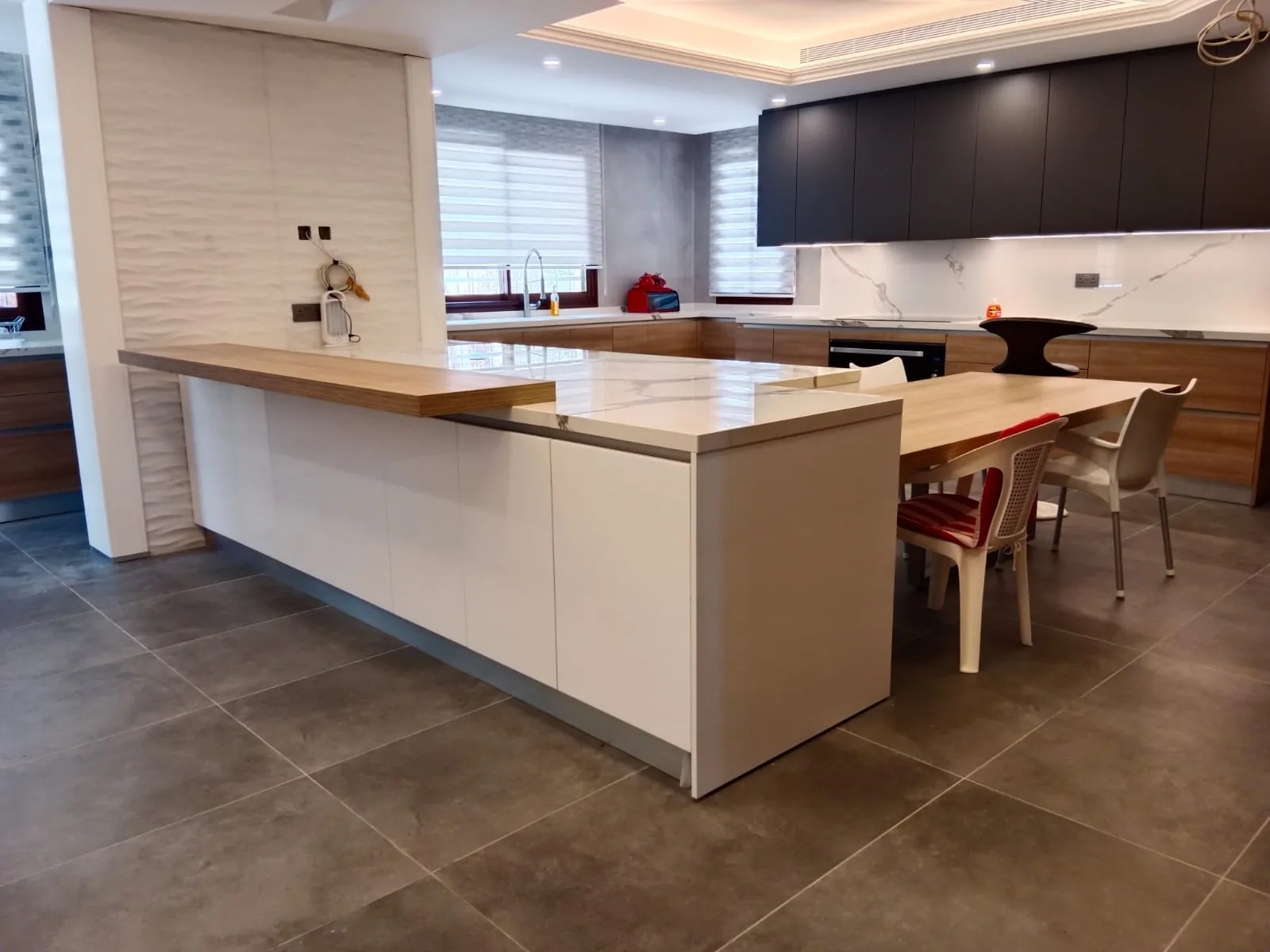 HK kitchen executed in Hazmieh, Mount Lebanon — handleless white lacquer kitchen with Calacatta marble waterfall island and oak breakfast bar — KITWOOD completed project